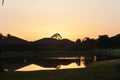 Sunrise and silhouette of houses and trees