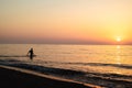 Sunrise silhouette of a man in Kamari beach, Greece Royalty Free Stock Photo
