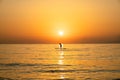 Sunrise silhouette of a man in a S.U.P. (paddle) board in Kamari beach, Greece Royalty Free Stock Photo