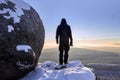 Sunrise, silhouette on the snowy rock