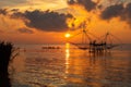 Sunrise sky with fisherman on square dip net and tourism boat at Pakpra village Royalty Free Stock Photo