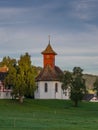 Sunrise on a small chapel in the Swiss countryside