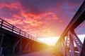 Sunrise with spectacular sky over an old iron bridge Royalty Free Stock Photo