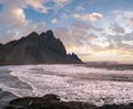 Sunrise Stokksnes cape sea beach and Vestrahorn Mountain with and ocean surf. Amazing nature scenery, popular travel destination