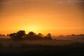 Sunrise on a summer morning in the countryside, morning fog, idyllic view. Leisure in the countryside. Royalty Free Stock Photo