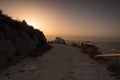 The sunrise sun appears around the bend at the end of the dirt road, Spain Royalty Free Stock Photo