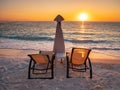 Sunrise with sun chairs and umbrella on the seashore at Marble Beach on the Greek Island Thasos in the Aegean Sea Royalty Free Stock Photo