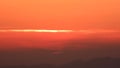 Sunrise Sun Rising in the Hazy air Below the Thin Orange Cloud Line