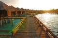 Sunrise with sunlight falling on the overwater villa at a tropical resort island, Maldives
