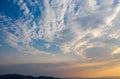 Sunrise, sunset clouds over land silhouette and sea. Twilight, dusk cloudy sky