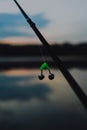 Sunrise or sunset fishing. Fishing rods on the background of the lake. Sports fishing. The bell hangs on a fishing line. selective Royalty Free Stock Photo