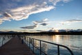 Sunrise sunset gazing from wooden pier over sea, copy space, wallpaper. Royalty Free Stock Photo