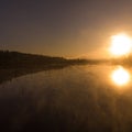 Sunrise or sunset on the lake with fog and steam Royalty Free Stock Photo