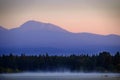 Sunrise Sunset on Lake with Mist Rising from Water Pine Trees and Mountains in Background Mt Sawtell Royalty Free Stock Photo