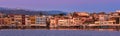 Sunrise or sunset over Old Venetian port and harbour promenade of Chania, Crete, Greece. Great purple sky, distant