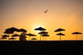 Sunrise with sunshade and life guard station silhouette Royalty Free Stock Photo