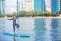 Sunrise SUP Yoga practice in Waikiki tree pose Royalty Free Stock Photo