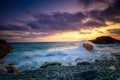 Sunrise time at the sea. Sea Ocean. Big roks. Wave hit the rock at beach, sea water splash up to the sky with sun. Sunset Sundown