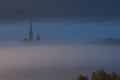 Ieud wooden church in Romania at sunrise. Gorgeous landscape. Colorful fog, at first sunrays of the day. 