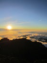 Sunrise at the top of Mount Rinjani in Lombok Island, Indonesia. View of crater lake covered in clouds from the summit. Beautiful