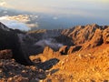 Sunrise at the top of Mount Rinjani in Lombok Island, Indonesia. View of crater lake covered in clouds from the summit. Beautiful