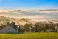 Sunrise, town and mountains in the fog, beautiful landscape Royalty Free Stock Photo