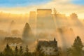 Sunrise, town and mountains in the fog, beautiful landscape Royalty Free Stock Photo