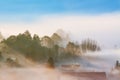 Sunrise, town and mountains in the fog, beautiful landscape Royalty Free Stock Photo