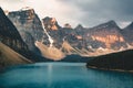 Sunrise with turquoise waters of the Moraine lake with sin lit rocky mountains in Banff National Park of Canada in Royalty Free Stock Photo