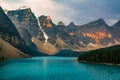 Sunrise with turquoise waters of the Moraine lake with sin lit rocky mountains in Banff National Park of Canada in Royalty Free Stock Photo