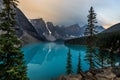 Sunrise with turquoise waters of the Moraine lake with sin lit rocky mountains in Banff National Park of Canada in Royalty Free Stock Photo