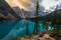 Sunrise with turquoise waters of the Moraine lake with sin lit rocky mountains in Banff National Park of Canada in Royalty Free Stock Photo