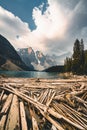 Sunrise with turquoise waters of the Moraine lake with sin lit rocky mountains in Banff National Park of Canada in Royalty Free Stock Photo