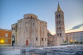 Sunrise view of Bell tower between Saint Donatus church and Saint Anastasia cathedral in Zadar, Croatia Royalty Free Stock Photo