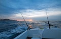 Sunrise view of fishing rod on charter fishing boat on the Pacific side of Cabo San Lucas in Baja California Mexico