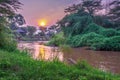 Sunrise view of Ishasha river, with trees growing and the reflections on the water, Queen Elizabeth National Park, Ishasha