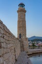 Sunrise view of a lighthouse at the old Venetian harbor at Greek