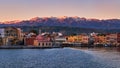 Sunrise view of Old Venetian harbour of Chania, Crete, Greece, its quay side. Great Cretan mountains covered with snow Royalty Free Stock Photo