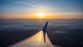 Sunrise view out of an airplane window. Plane flying over the clouds Royalty Free Stock Photo