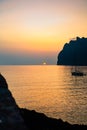 Sunrise Over a Tranquil Bay in the Mediterranean Sea With Mountains and Sailboat Royalty Free Stock Photo