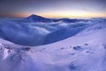 Sunrise view of Pec pod Snezkou in the Krkonose Mountains in winter. Czech Republic. Morning panoramic view above clouds. Royalty Free Stock Photo