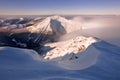 Sunrise view of Pec pod Snezkou in the Krkonose Mountains in winter. Czech Republic. Morning panoramic view above clouds.