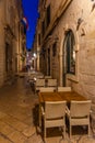 Sunrise view of restaurant tables at a narrow street in the old town of Dubrovnik, Croatia