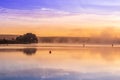 Sunrise view of a still, silent dam with boat jettyÃ¢â¬â¢s in the foreground, Club Elani Resort