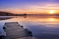 Sunrise view of a still, silent dam with boat jettyÃ¢â¬â¢s in the foreground, Club Elani Resort