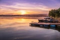 Sunrise view of a still, silent dam with boat jettyÃ¢â¬â¢s in the foreground, Club Elani Resort