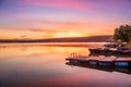 Sunrise view of a still, silent dam with boat jettyÃ¢â¬â¢s in the foreground, Club Elani Resort