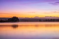 Sunrise view of a still, silent dam with boat jettyÃ¢â¬â¢s in the foreground, Club Elani Resort