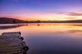 Sunrise view of a still, silent dam with boat jettyÃ¢â¬â¢s in the foreground, Club Elani Resort