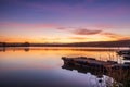 Sunrise view of a still, silent dam with boat jettyÃ¢â¬â¢s in the foreground, Club Elani Resort